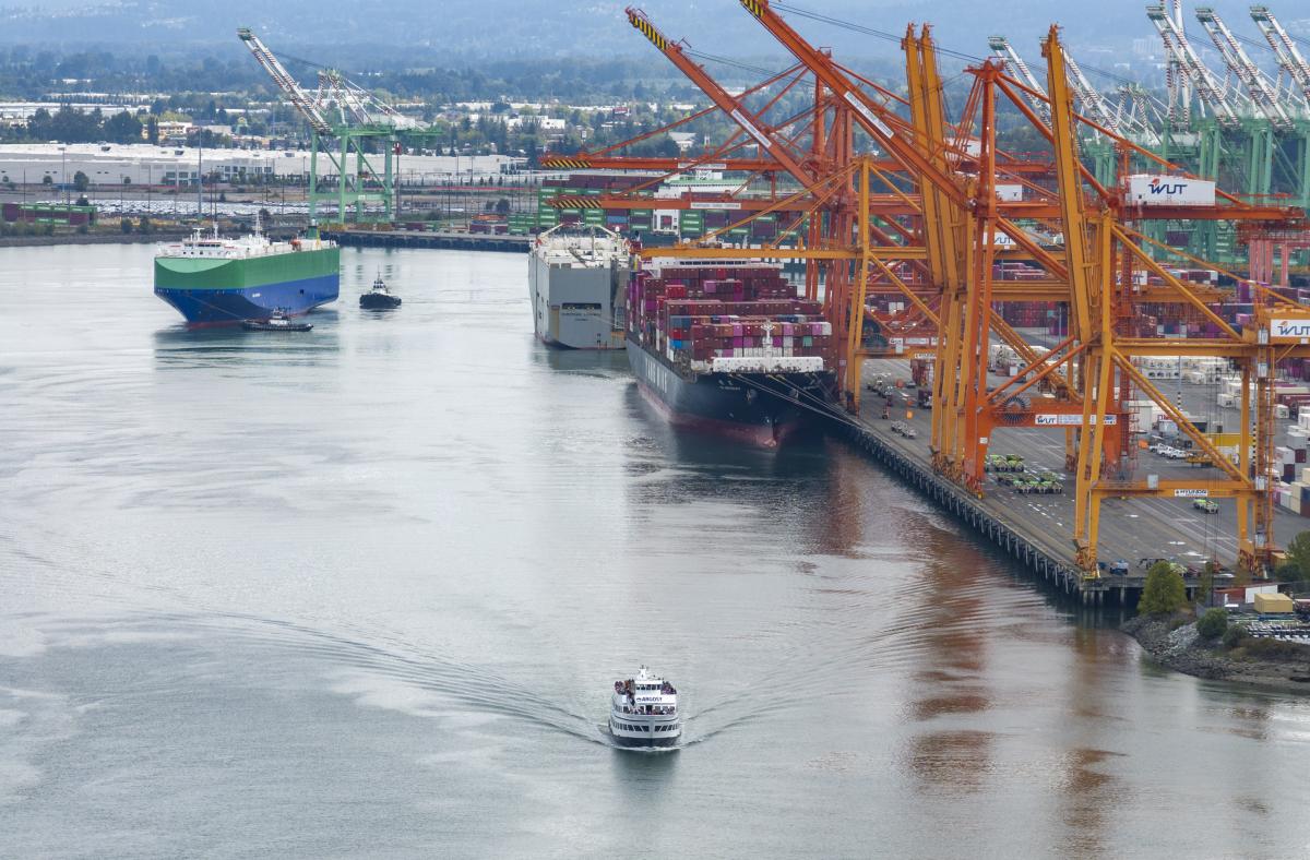 The Spirit of Seattle cruises up the Blair Waterway with Washington United Terminal and Pierce County Terminal in the background