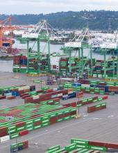 Aerial view of a port terminal filled with shipping containers.