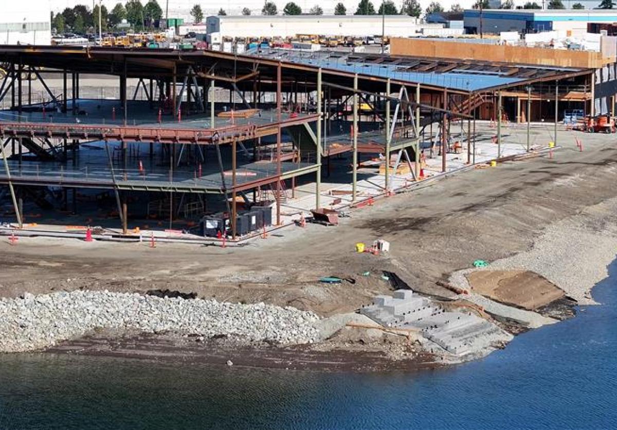 Aerial shot of a building under construction along the shoreline.