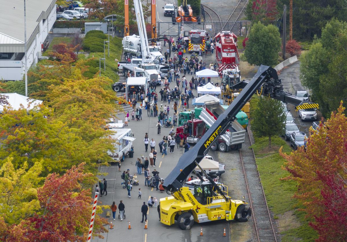 Overhead shot of a street lined with people and construction vehicles.
