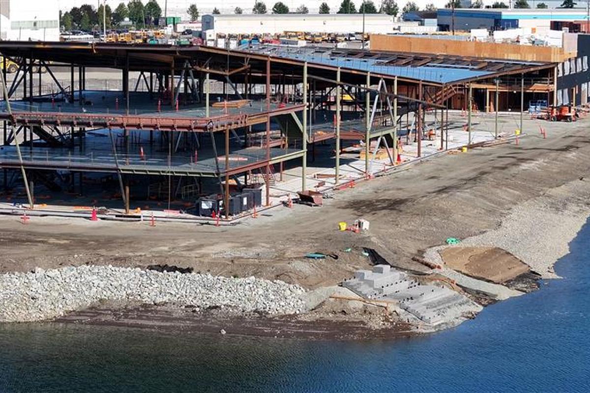 Aerial shot of a building under construction along the shoreline.
