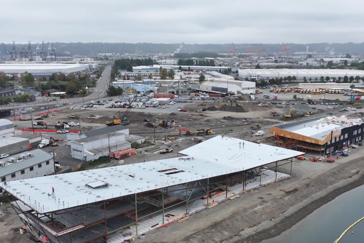 Aerial shot of a building under construction near a waterway.