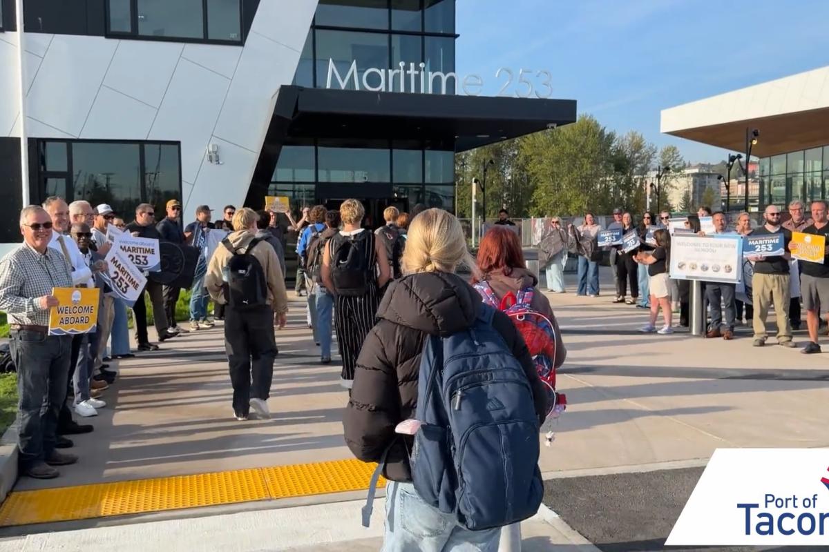 Thumbnail of students walking into the Maritime|253 skills center while a group of adults cheer and hold signs.