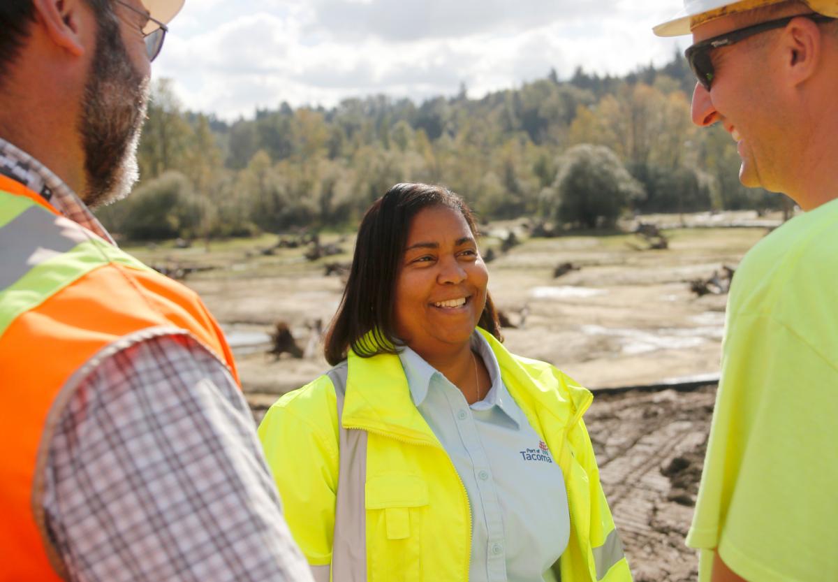 photo of a woman speaking with two men
