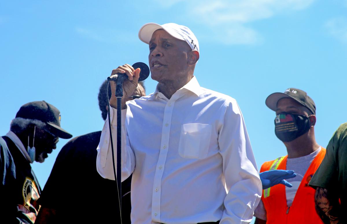 photo of a man speaking in front of other people