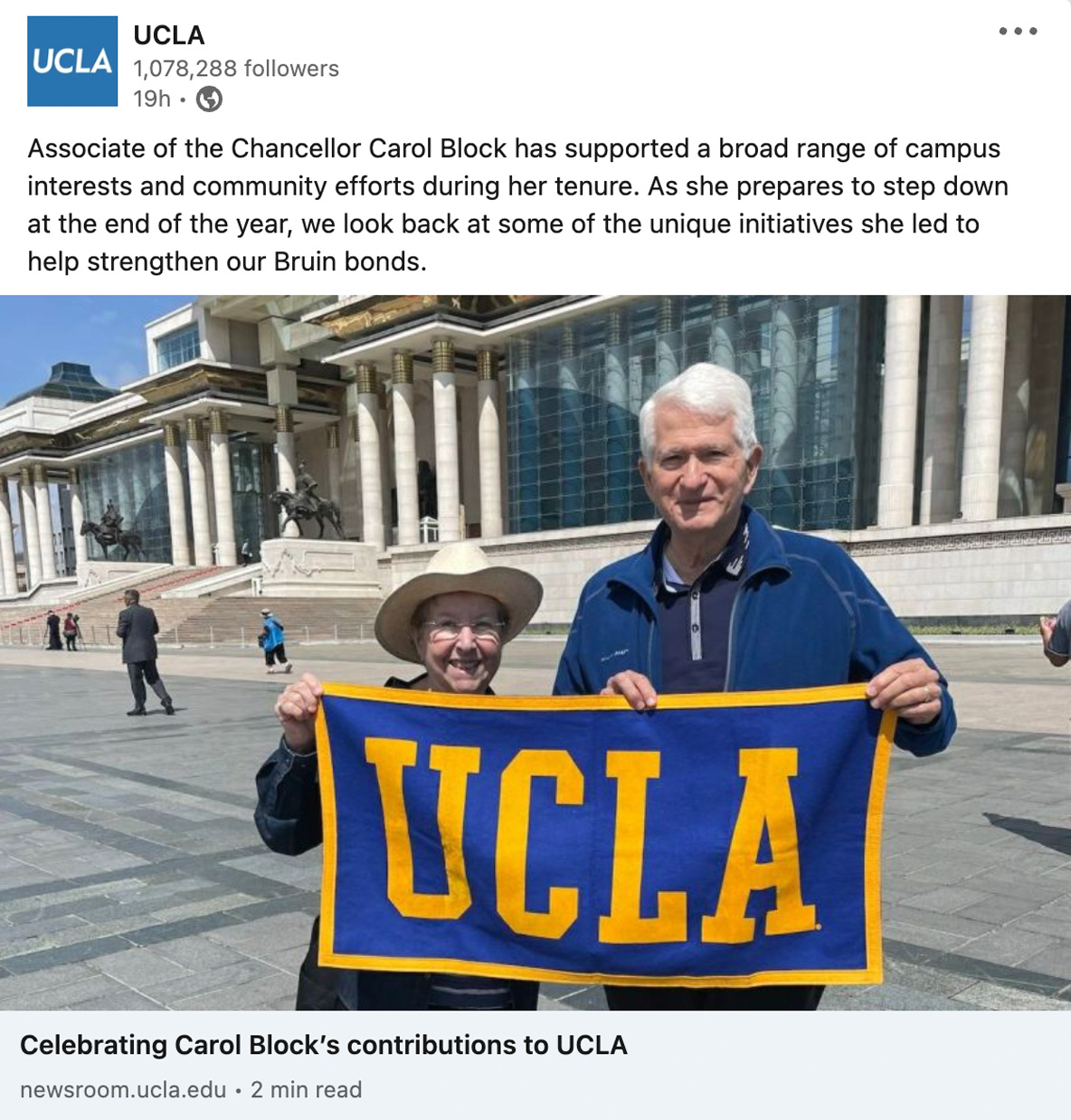 Associate of the Chancellor Mrs. Carol Block and Chancellor Gene Block hold up a UCLA banner.