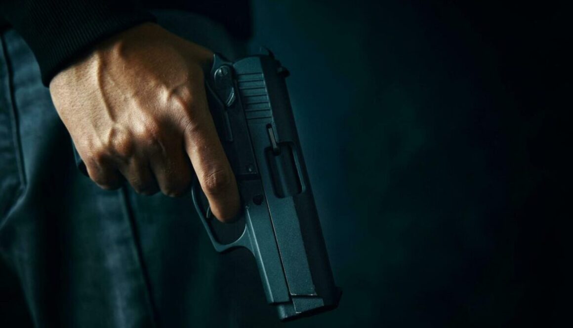 criminal-with-revolver-on-dark-background-photo