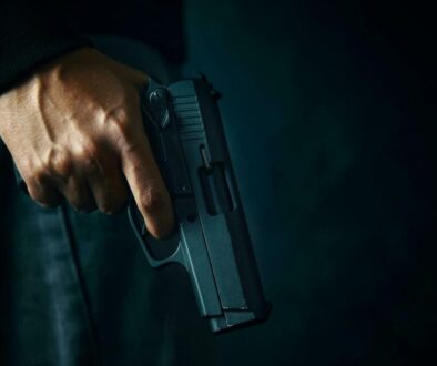criminal-with-revolver-on-dark-background-photo