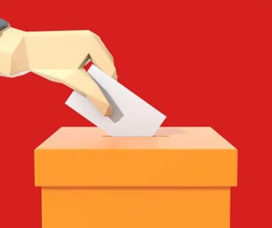 Hand putting voting paper in the ballot box, Voting concept