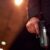 Unrecognizable person holding a handgun at night