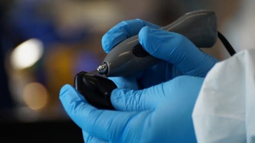 Dexis sensor repair: a Sodium Dental technician opening a Dexis x-ray sensor housing