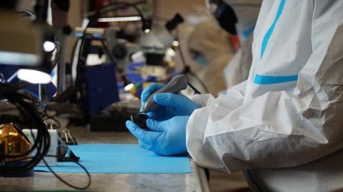 X-ray sensor repair: a Sodium Dental technician working on the cable connection of a dental x-ray sensor
