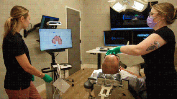 Alli guiding a team member through 3D scanner training on the Aoralscan Elite during a real full-arch case.