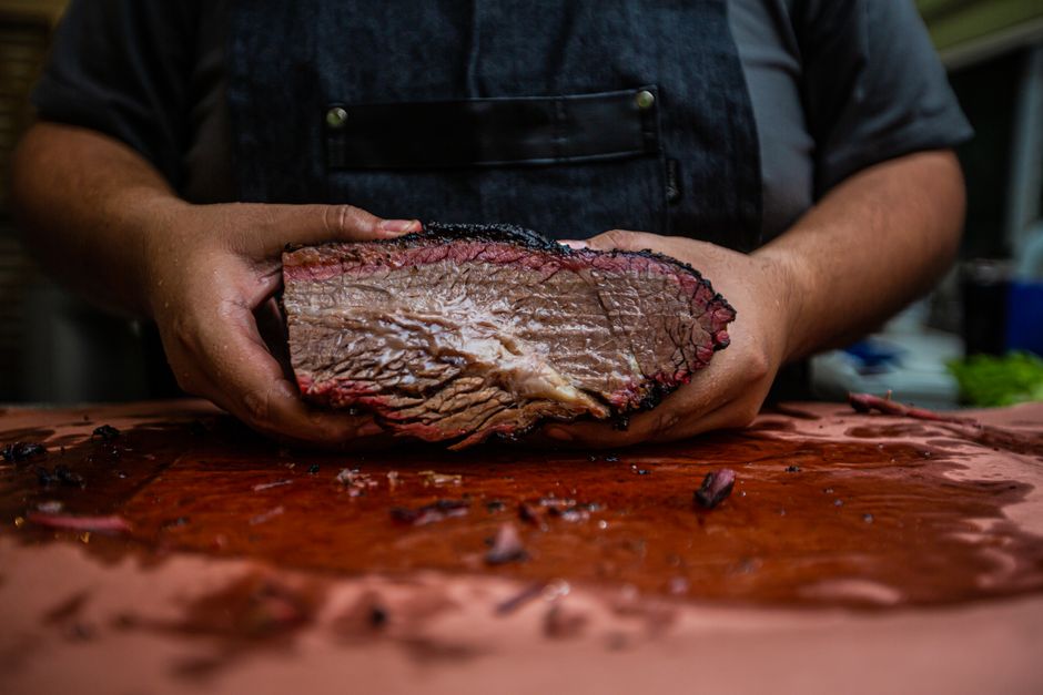 Sliced whole-packer brisket at Iron Oak Smokehouse — black bark, molten fat cap