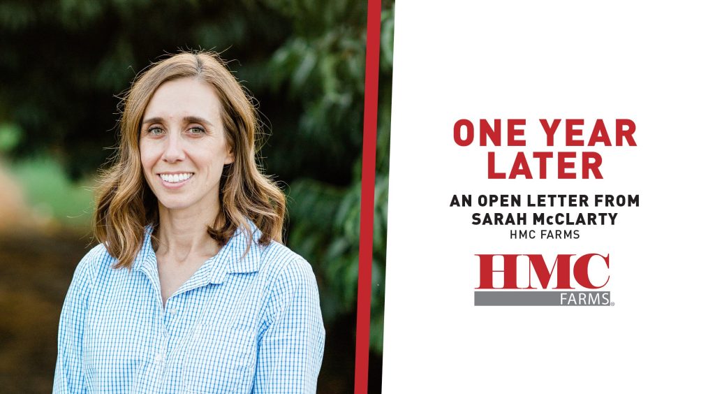Photo of CFO Sarah McClarty wearing a blue and white checkered shirt in a peach orchard with text that reads: one year later, an open letter from Sarah McClarty at HMC Farms