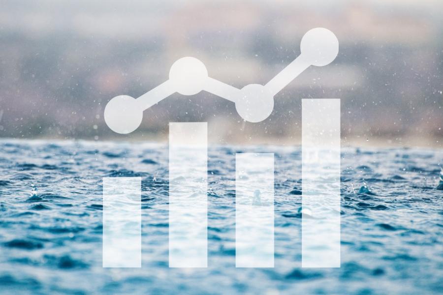 Rain drops on surface water with a chart icon overlaid on top