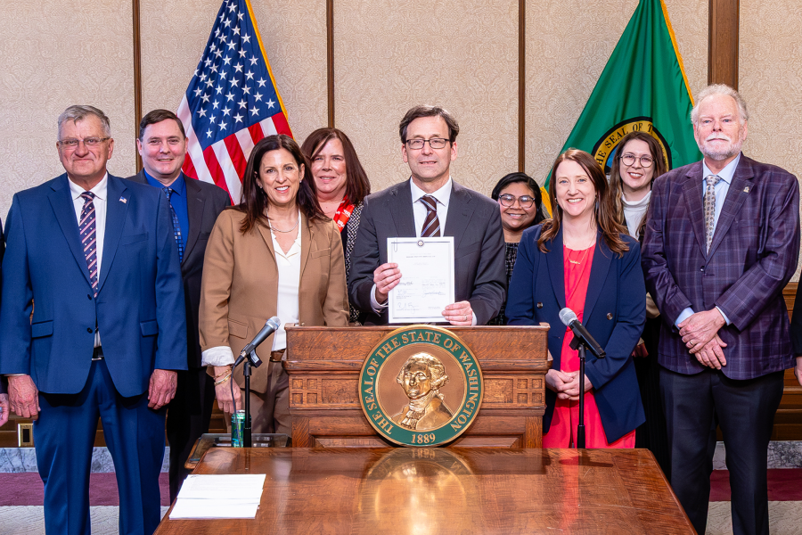 photo of the governor and the thurston county tax assessor signing the new senior tax exemption bill into law