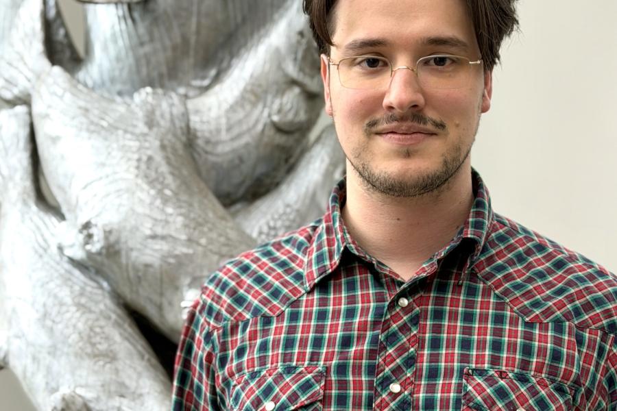 Bryan Benjamin, Thurston County's Natural Resources Program Manager standing in front of a sculpture of salmon
