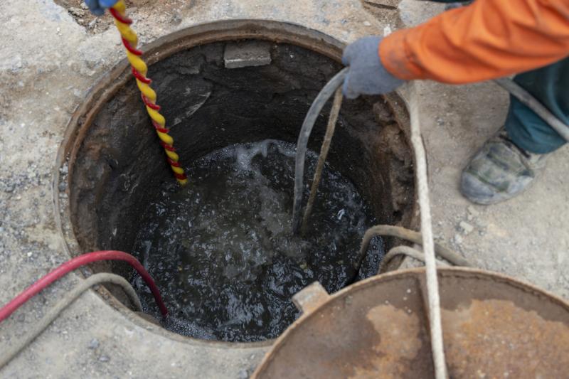 City municipal workers are doing urban sewer dredging stock phot