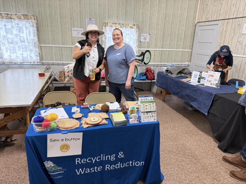 Thurston Solid Waste Recycling & Waste Reduction outreach booth with 2 educators.