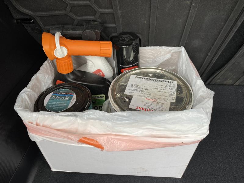 Photo of household hazardous wastes properly stored in a container for transportation.