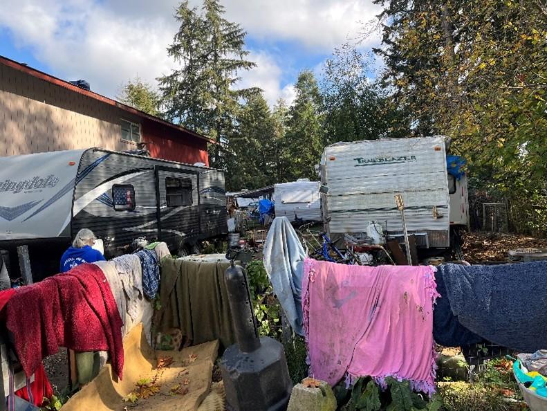 Picture of an RV with debris surrounding it creating a safety hazard