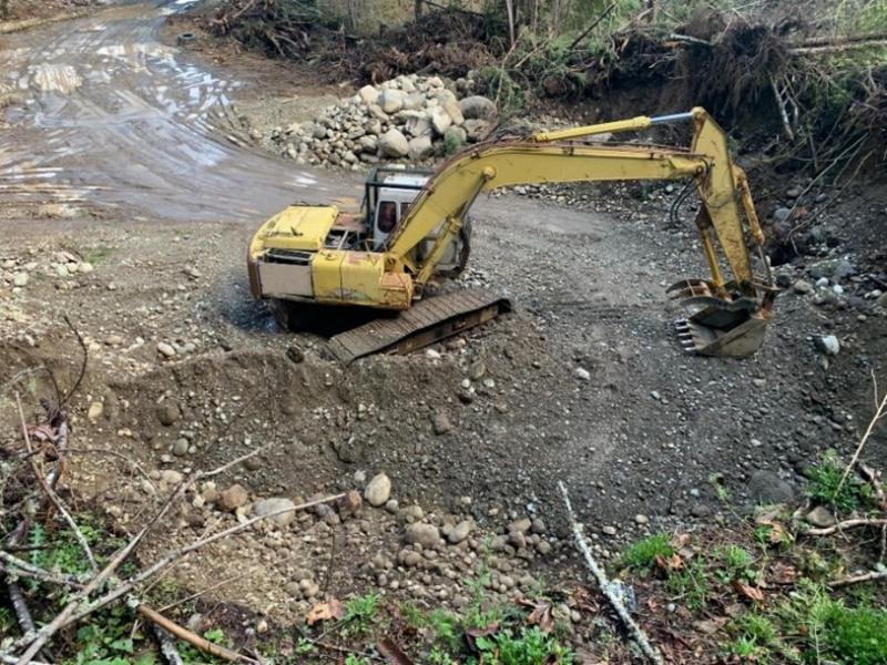 Tractor moving dirt to make a flat surface