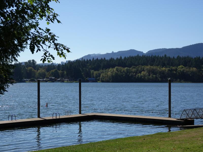 The dock extending out into the lake at Kenneydell Park.  The opposite shoreline and mountains are visible in the distance.
