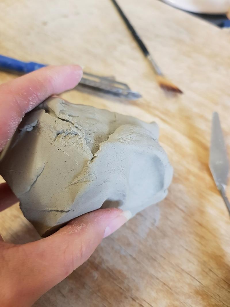 Sculpting Moment: Grey Clay and Artisan's Hand stock photo