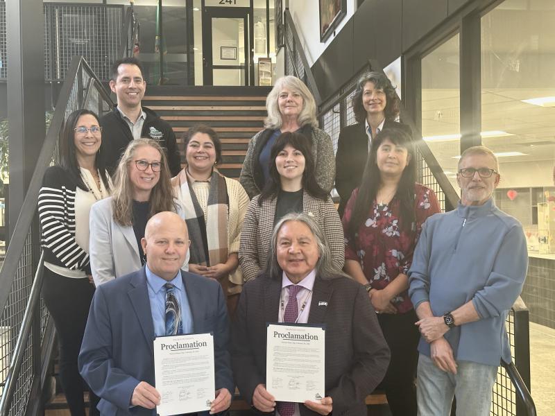 Board of Health members standing on stair case holding proclamation for national donor day 