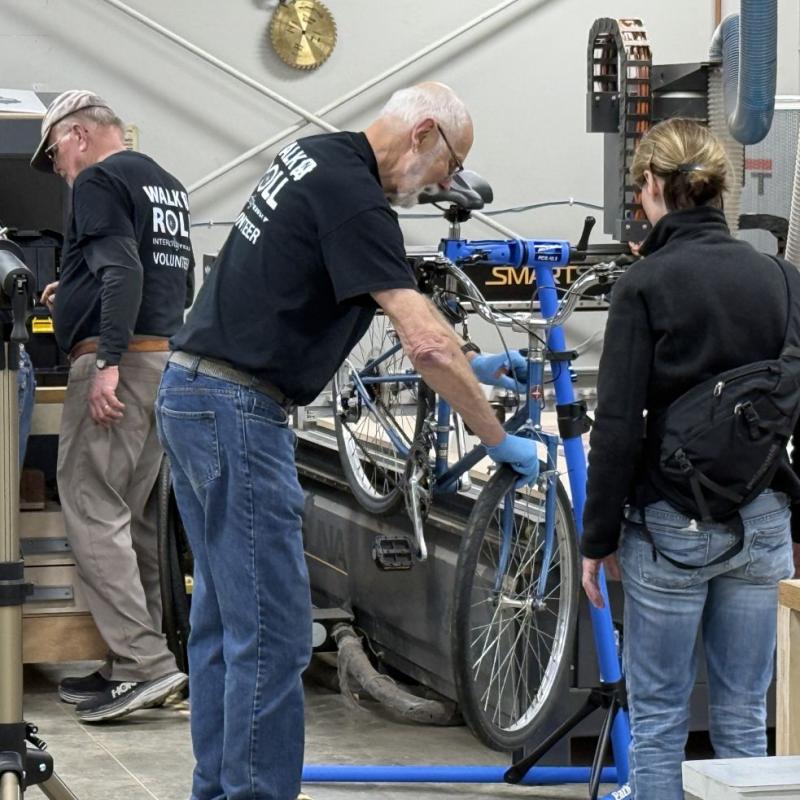 Volunteers repair a bicycle