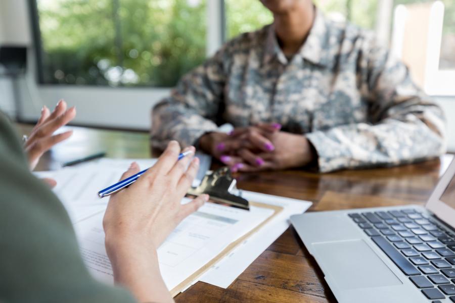 Image of active duty officer in uniform in meeting obtaining resources