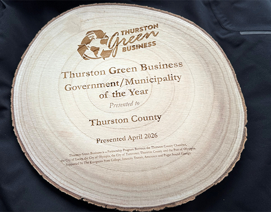 Image of a planed section of a tree log inscribed as an award for Thurston County Green Municipality of 2026