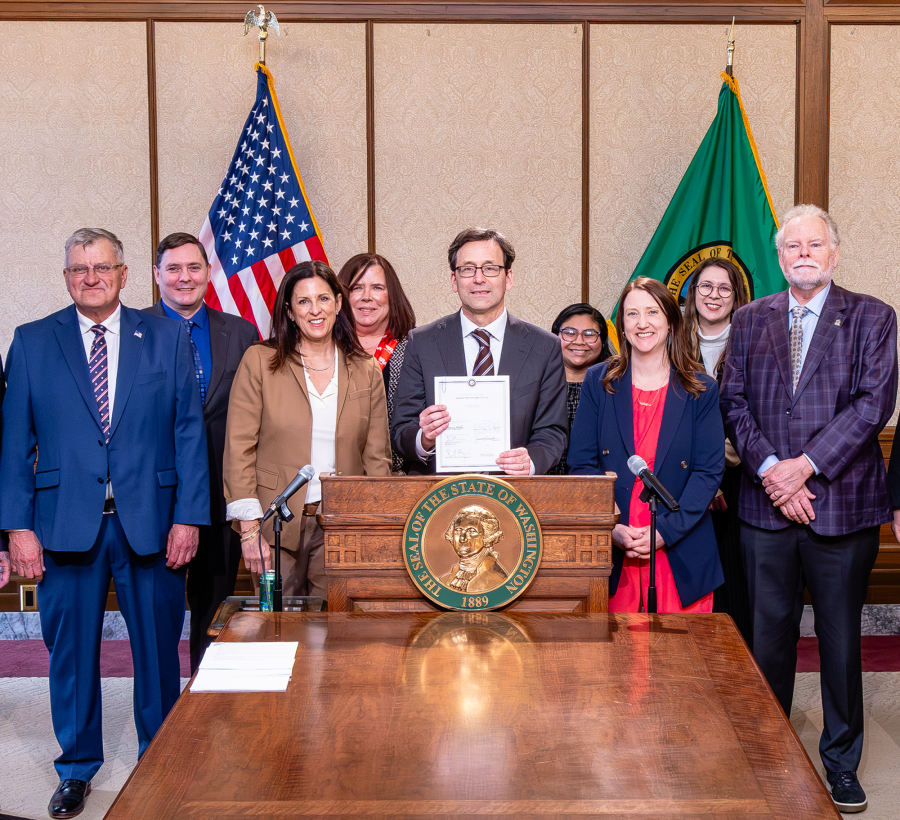 photo of the governor and the thurston county tax assessor signing the new senior tax exemption bill into law