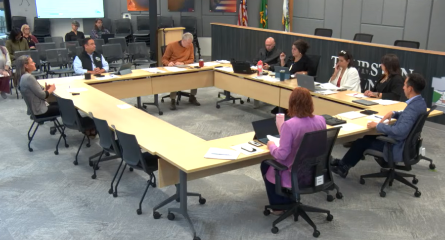 Image from a county budget meeting inside the Commissioners Board room with thurston county commissioners and county leaders sitting around a table.