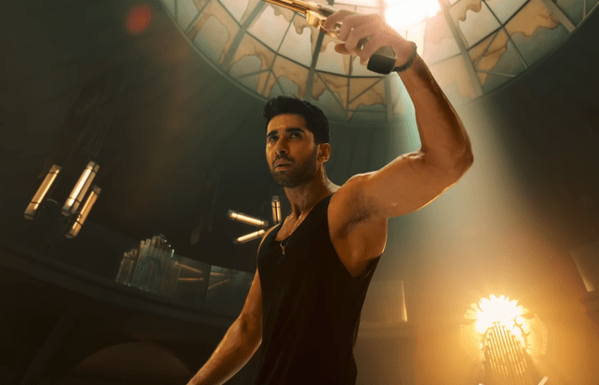 A man holding a gun in an action movie pose; Lakshya in 'The Ba***ds of Bollywood'