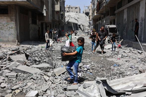 Palestinians salvage items from the rubble of homes destroyed in Israeli strikes on the southern al Zeitoun neighborhood in Gaza City, on August 19, 2025.