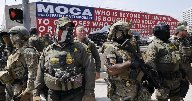 Los Angeles, CA - August 14: US Border Patrol march to the Edward R. Roybal Federal Building after a show of force outside the Japanese American National Museum where Gov. Newsom was holding a redistricting press conference on Thursday, Aug. 14, 2025 in Los Angeles, CA. (Carlin Stiehl / Los Angeles Times)