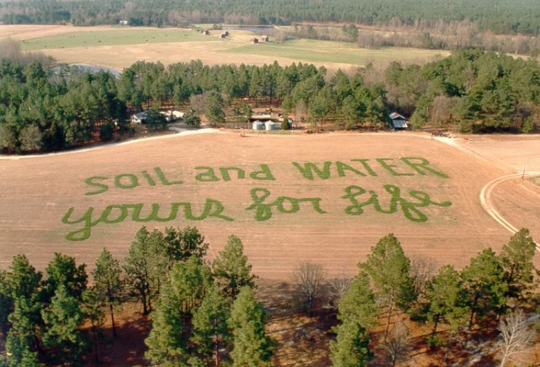 Soil and Water For Life spelled out in agricultural field