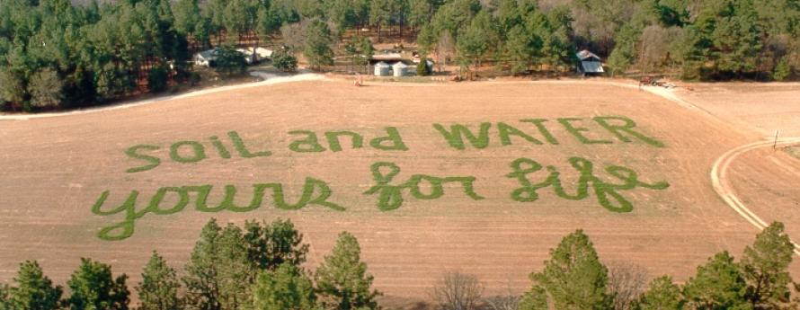 Soil and Water For Life spelled out in agricultural field