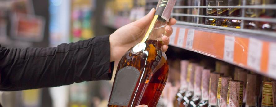 Person holding bottle of alcohol