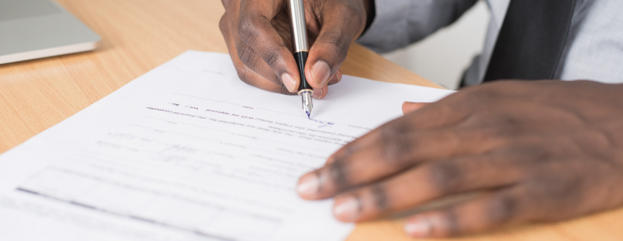 Man completing forms with a pen