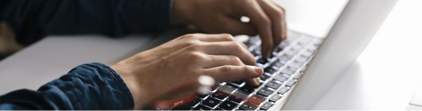 A person typing on a laptop