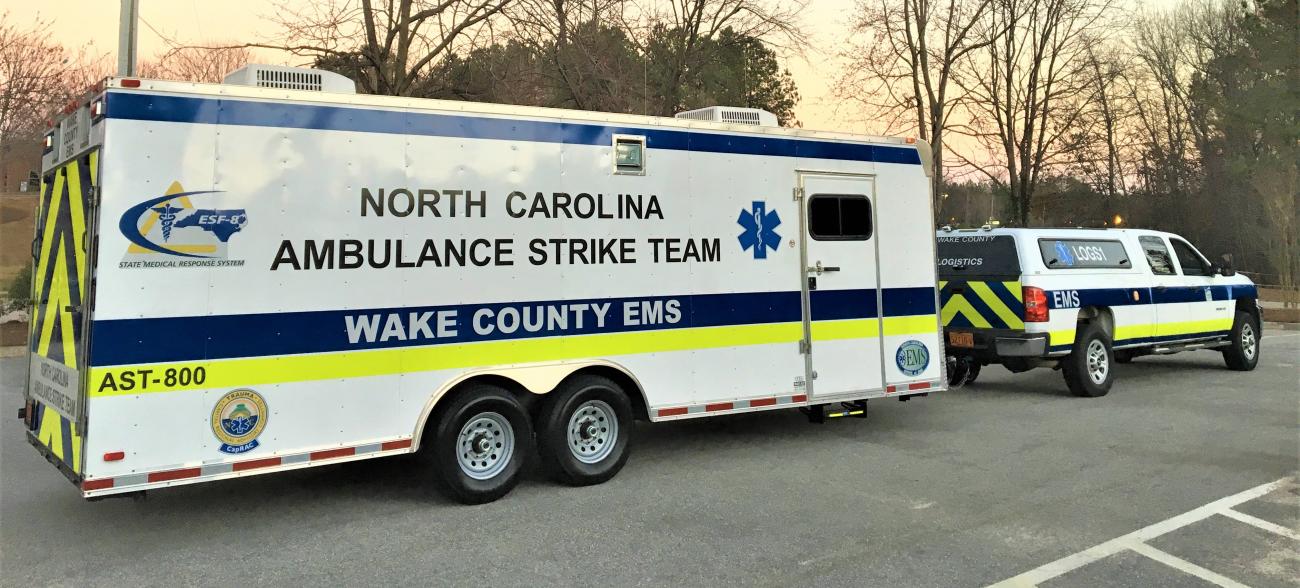 Ambulance strike team trailer parked at dusk in winter