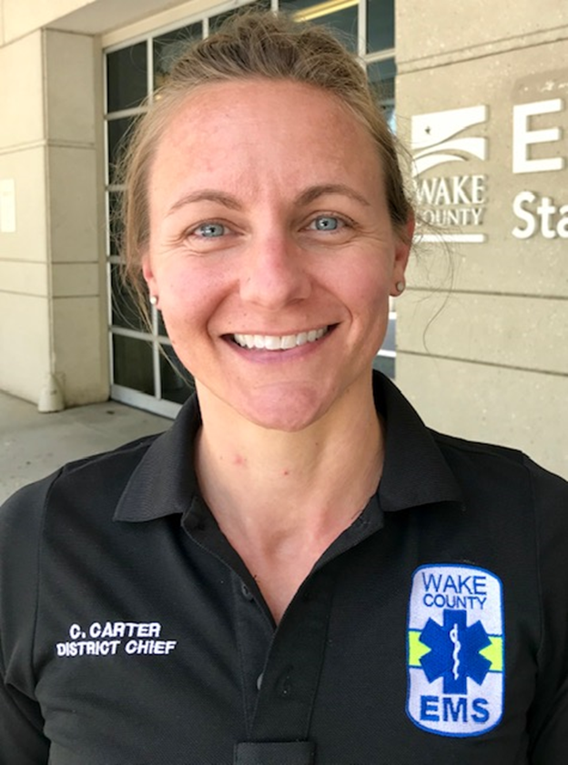 Candice Carter smiling in front of ambulance bay