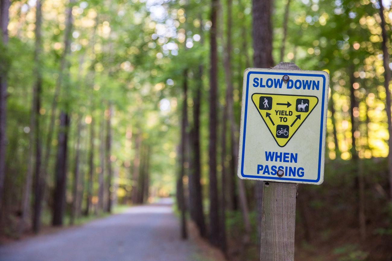 View of the American Tobacco Trail with "Wheels Yield to Heels" sign