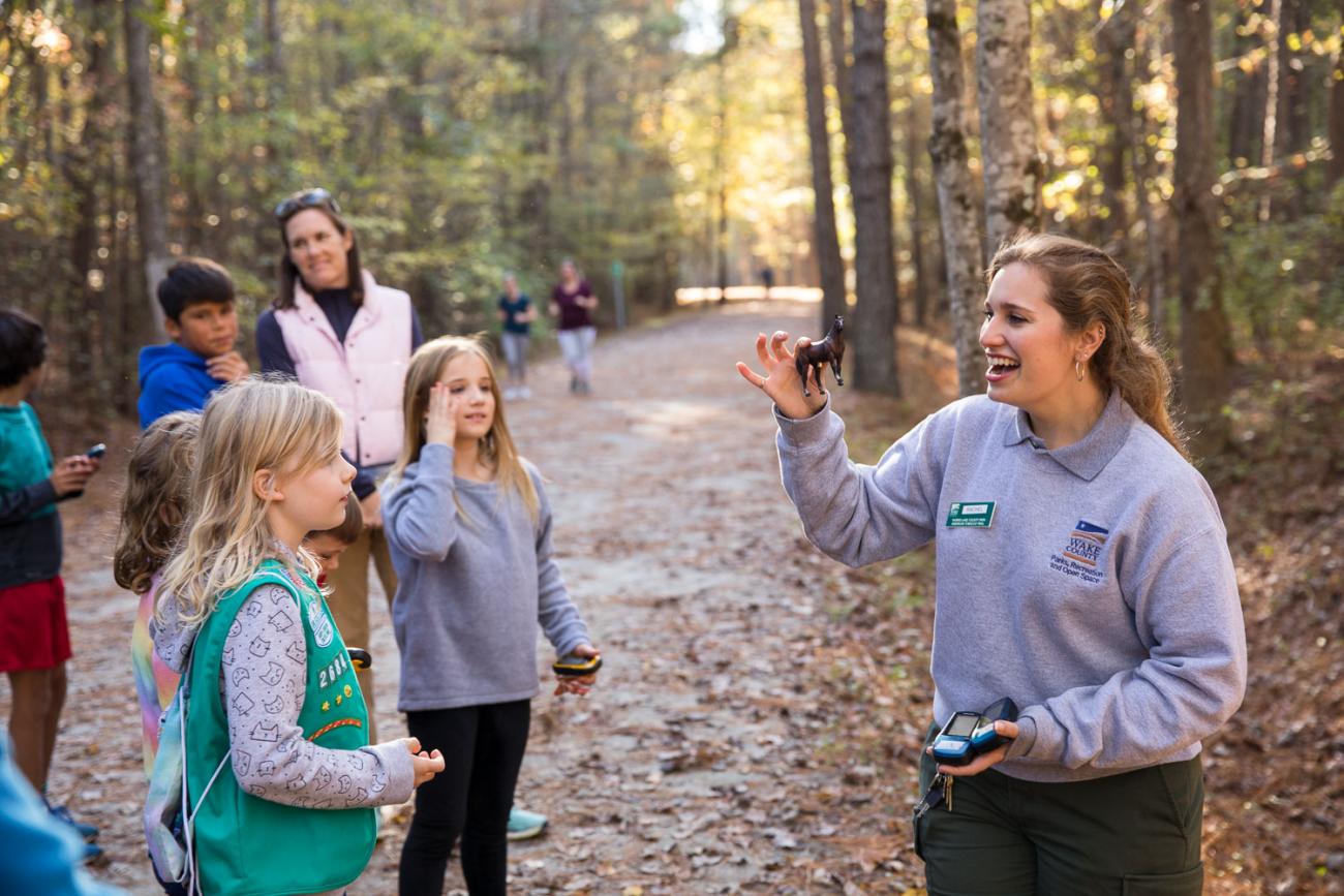 Photo of a park educator with participants in a geocaching program
