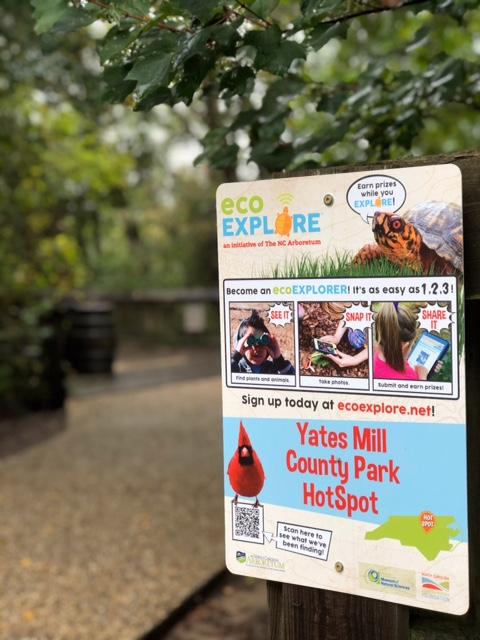 metal sign on wooden fence post promoting ecoexplore program