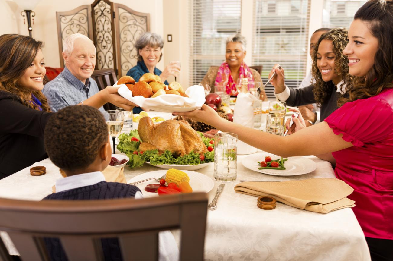 Family sitting around dinner table eating