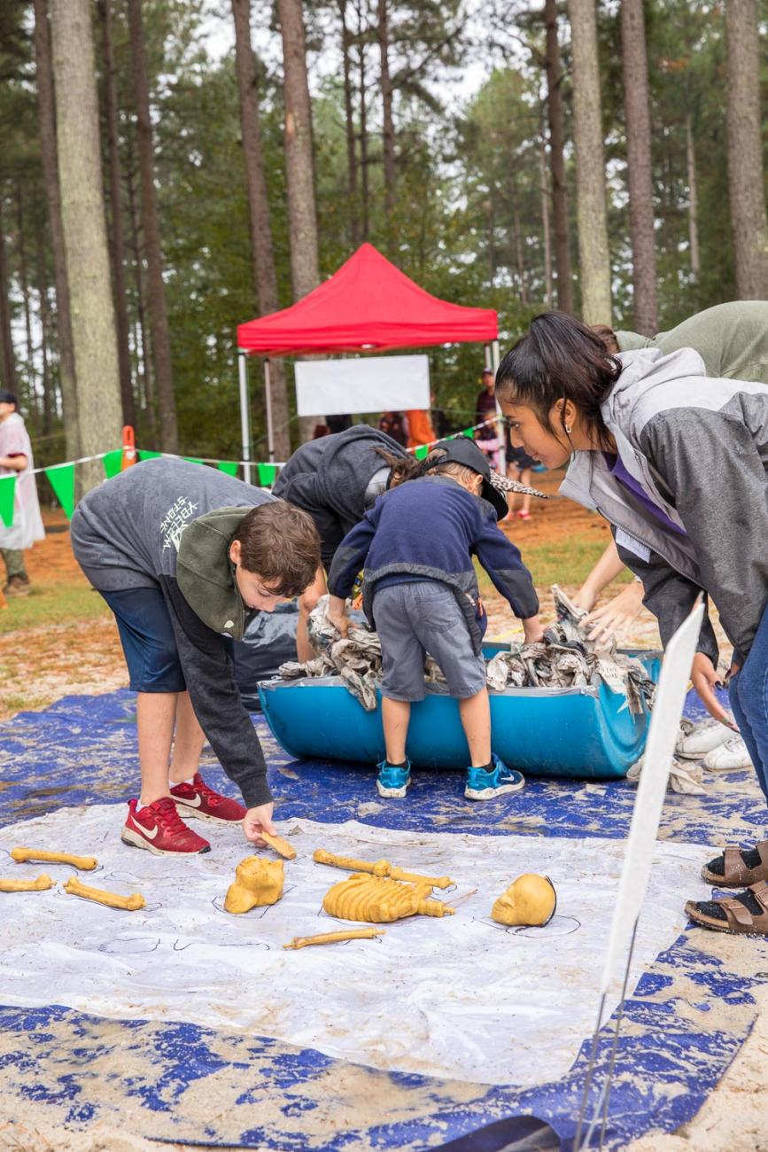 Photo of kids and volunteers playing a game at Haunting at Harris